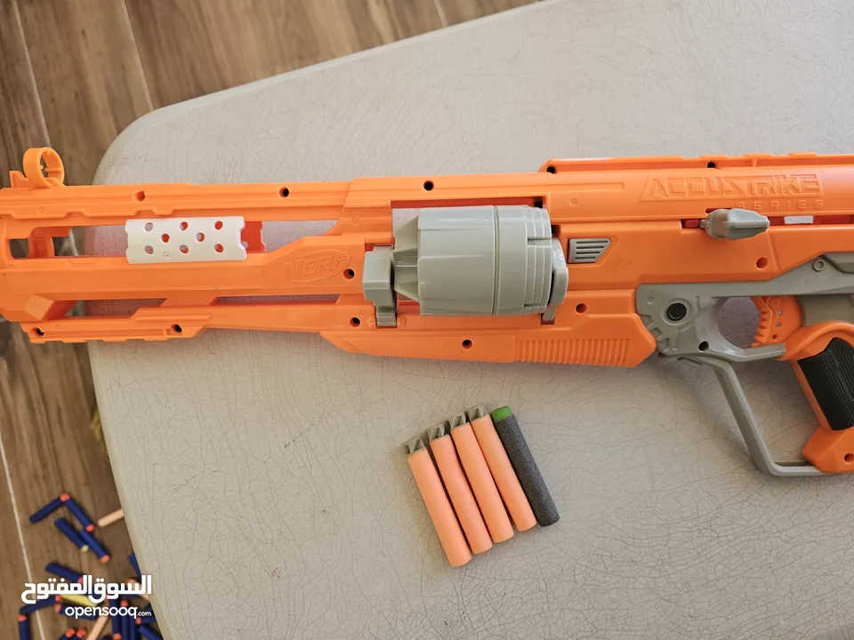 accustrike toy blaster with 5 bullets, 4 similar and 1 diffent