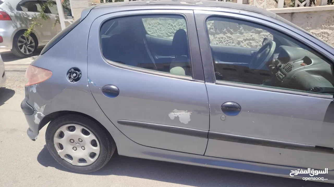 بيجو 2007 موديل 206 فحص كوم حديد 1300دينار