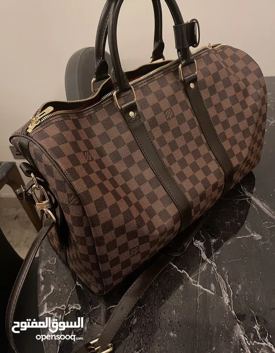 Louis Vuitton Keepall Bandoulière 50 - Timeless Elegance with a Pop of Red