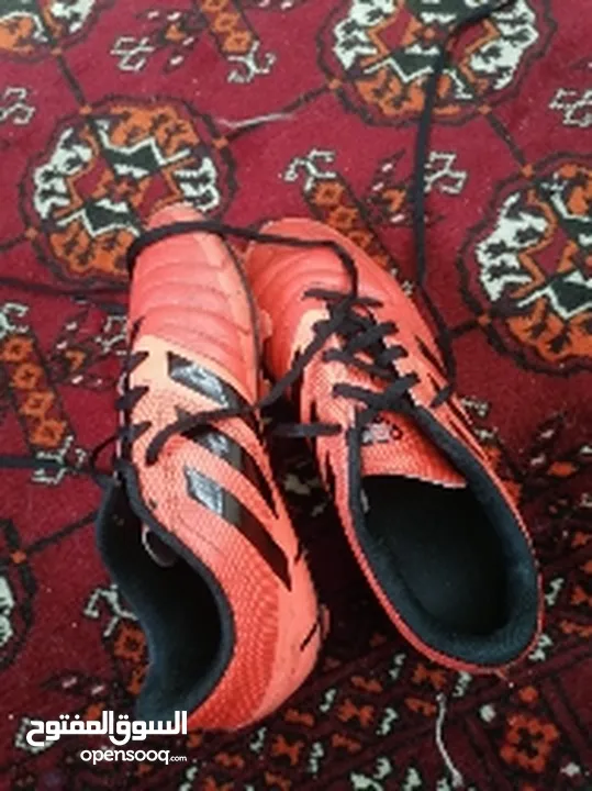 Used orange Adidas shoes