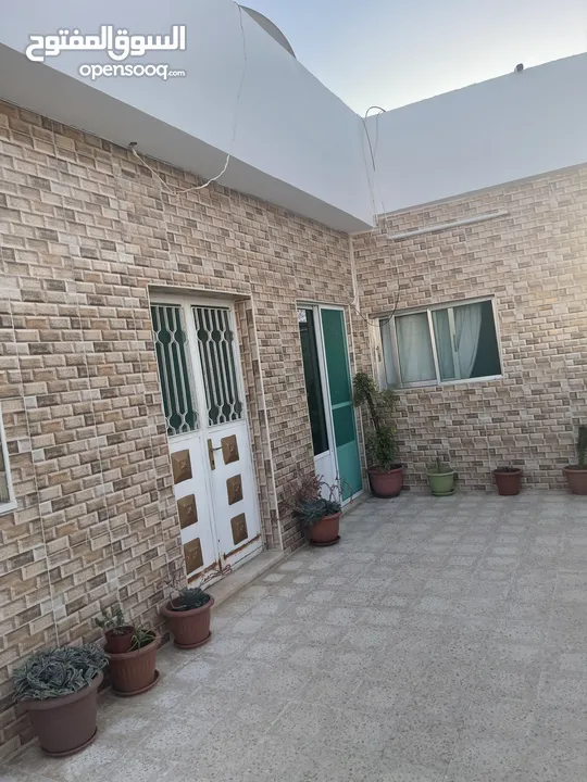ارض دونم مع بيت ارضي وبيت طابقين