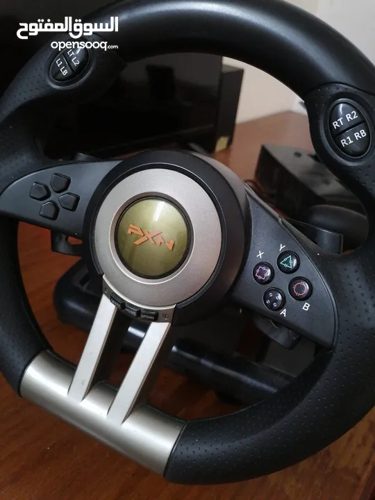 a pxn simulator pack with a steering wheel and a pedals with a gear shifter