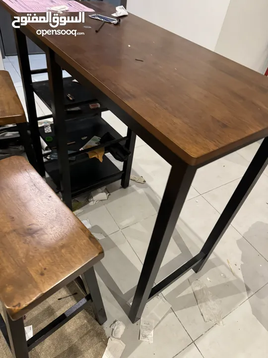 Wooden Table with two wooden stools.