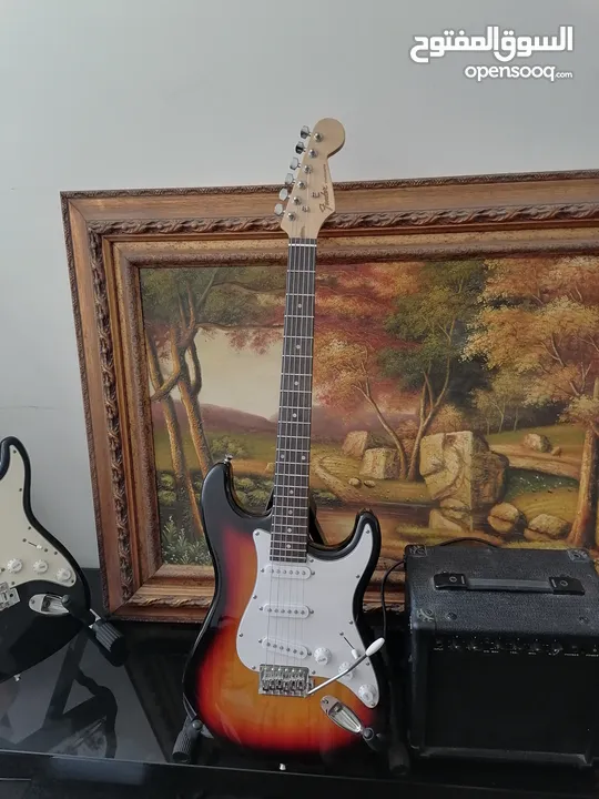 Fender electric guitar stratocaster replica with 10 watt amplifier.