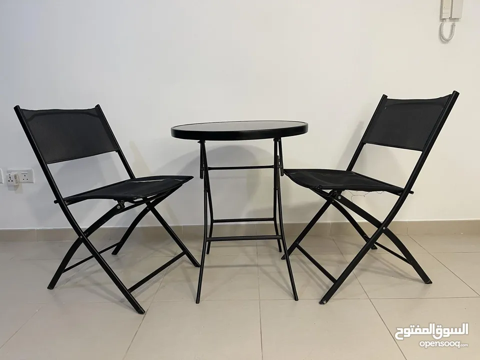 Black table with glass on top + 2 chairs