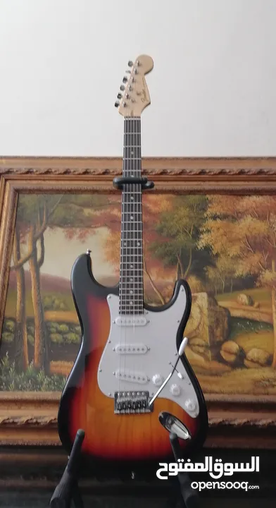 Fender electric guitar stratocaster replica with 10 watt amplifier.