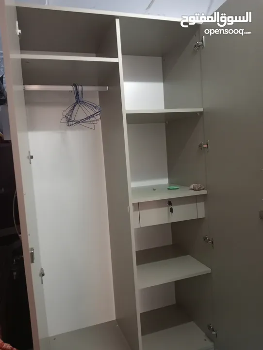 cupboard and single wide bed with mattress