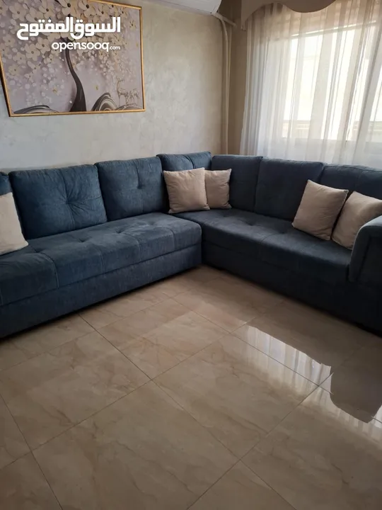 كنب زاويه حرف ل بلون تركواز انيق يتحول الى سرير كبير تصميم عملي وعصري بحاله شبه جديد للبيع بالمدينه