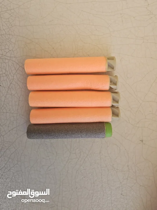 accustrike toy blaster with 5 bullets, 4 similar and 1 diffent