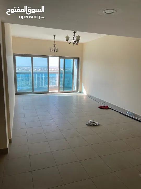 Directly from the Owner : Spacious 2BR Apartment  Sea View  1 Car Parking Free  On Dubai Border