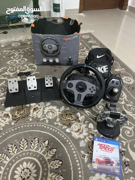 PS4 + Racing Set + 2 Games + 2 Controllers بلايستيشن 4 مع عدة سياقة