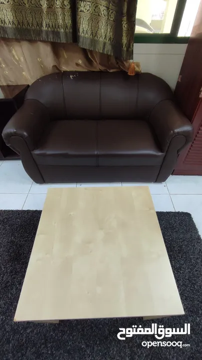 Two-seater leather sofa with wood table