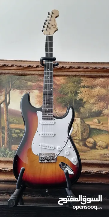 Fender electric guitar stratocaster replica with 10 watt amplifier.