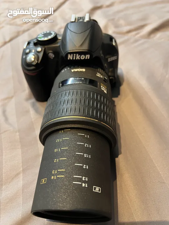 كاميرا Nikon 3100 مستعمله بحالة الوكاله معها عدستها الاصليه ومعها عدسة Sigma macro يابانيه اصلية