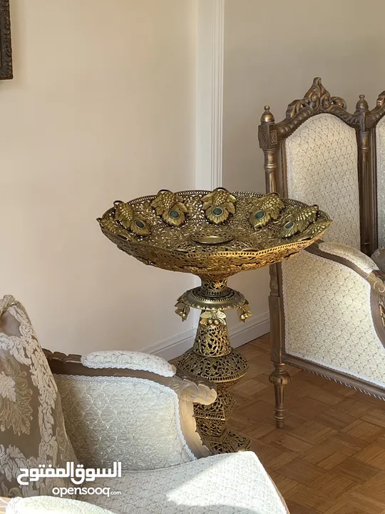 A tall brass fruit bowl