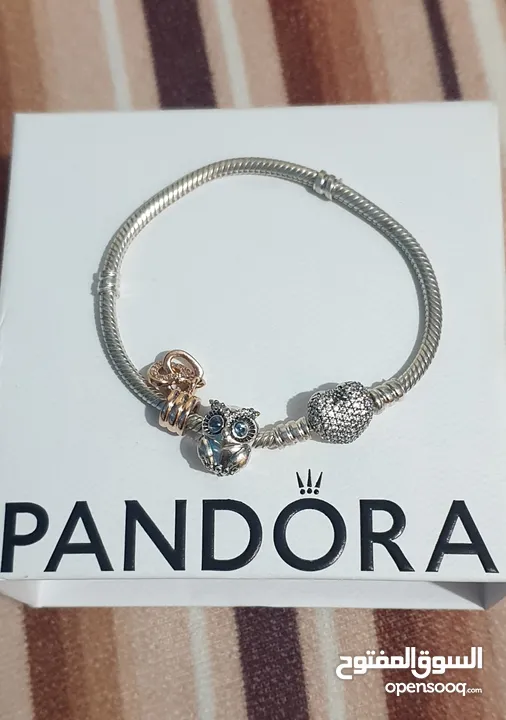 PANDORA sliver bracelet with heart shaped clasp with some charmsاسواة باندورا فضة بشكل قلب مع إضافات