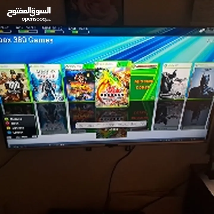 XBOX 360 with 180 games , 2 controllers, a camera sensor and a charger