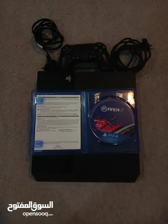 PlayStation 4 with controller, FIFA 19 and cables