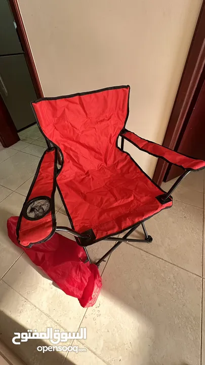 كرسي تخييم احمر جديد -"Red camping chair, new."