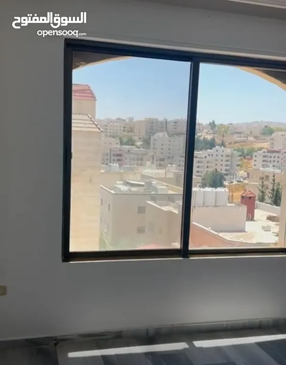 Excellent natural light and winds with views of Shafa Badran from the highest level in the building.