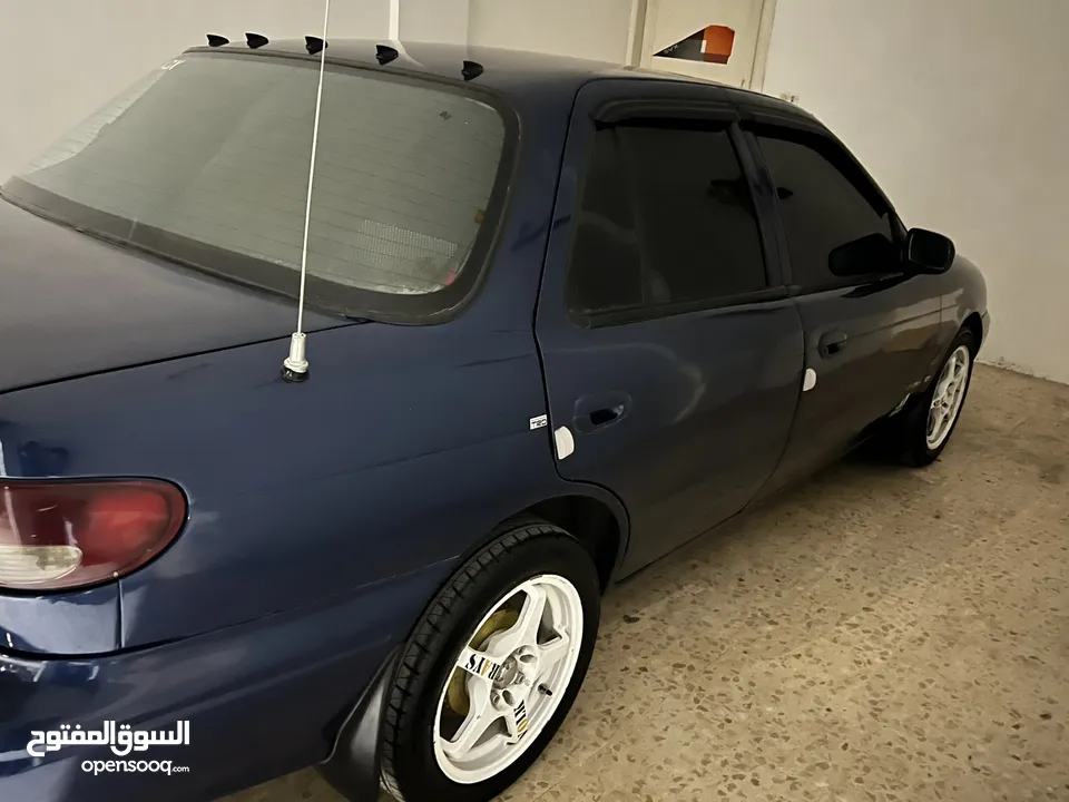 كيا سيفيا لون ازرق ميتالك نظيفه مع جنط 15 مميز كاوشوك وكاله غرفه نطيفه بطاريه جديده لسى كفالتها معها
