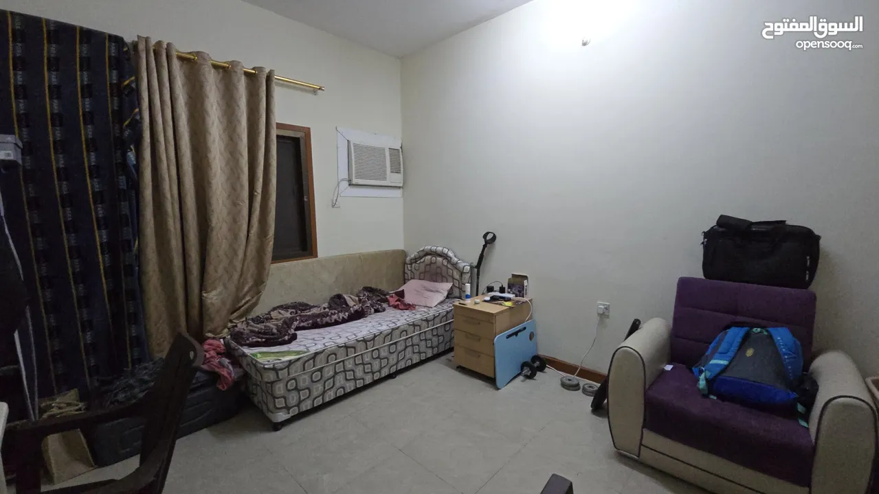 A room or bed space is available in a shared flat located behind Jasmine Complex in Al Khuwair