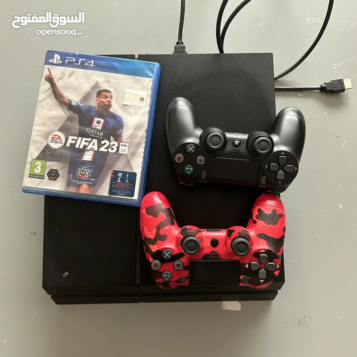 PS4 , a cd for FIFA 23 and 2 pads on it