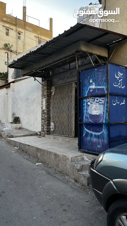 سوبر ماركت على الشارع الرئيسي في جبل الجوفة للبيع خلو