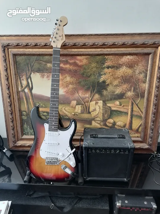 Fender electric guitar stratocaster replica with 10 watt amplifier.