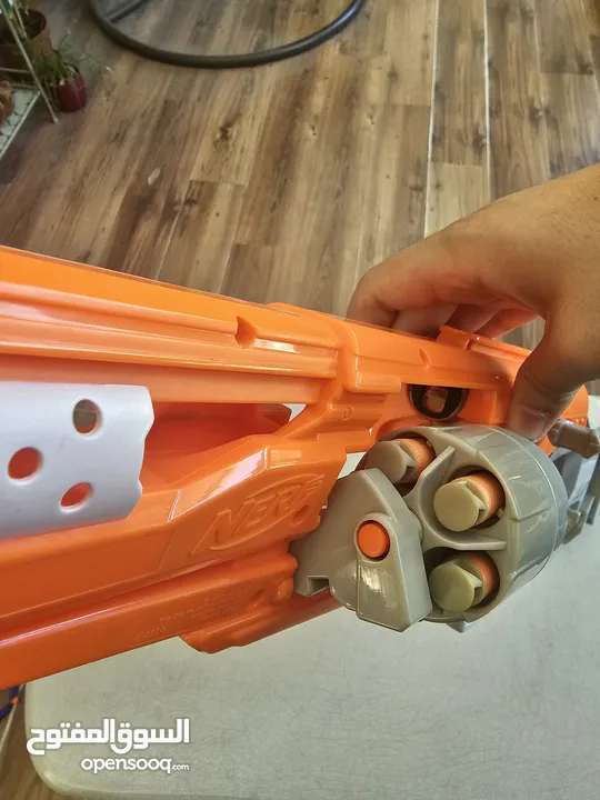 accustrike toy blaster with 5 bullets, 4 similar and 1 diffent