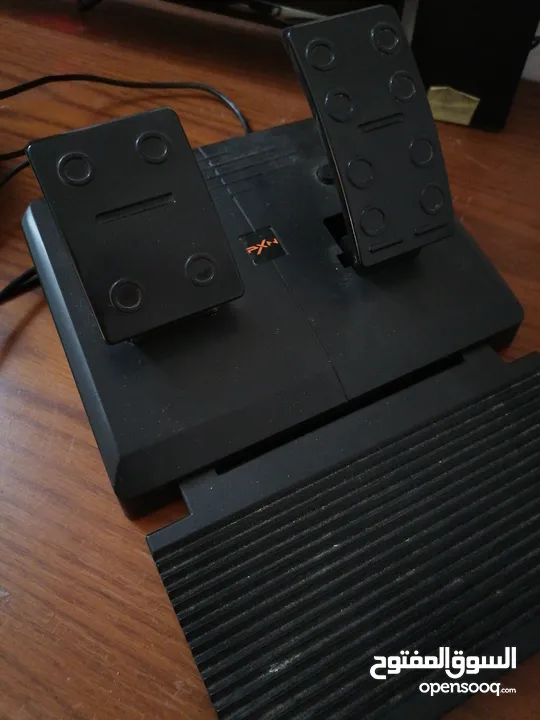 a pxn simulator pack with a steering wheel and a pedals with a gear shifter
