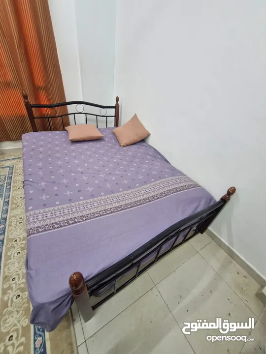 Iron and wood bed for sell in a very good condition .