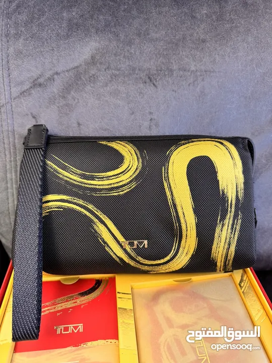 Tumi Clutch “Year of the Snake” and Kinetic Perfume