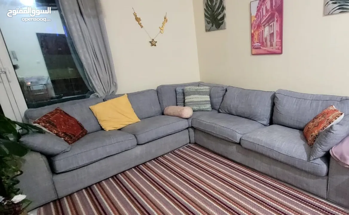 A L-shaped sofa with two small cracks at the bottom.  Please DM through WhatsApp