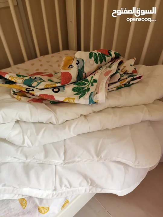 Different baby products (Bedding sets, sleeping bag, changing mat and baby head shaping pillow)