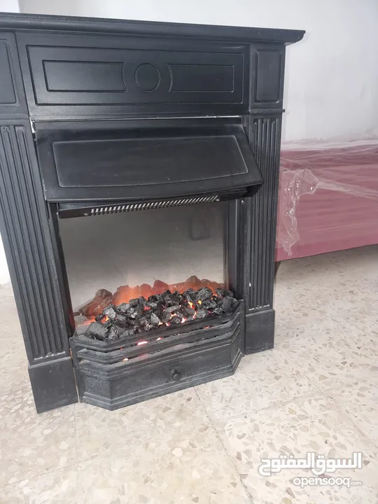 صوبة كهرباء على شكل موقد حطب مستعملة
