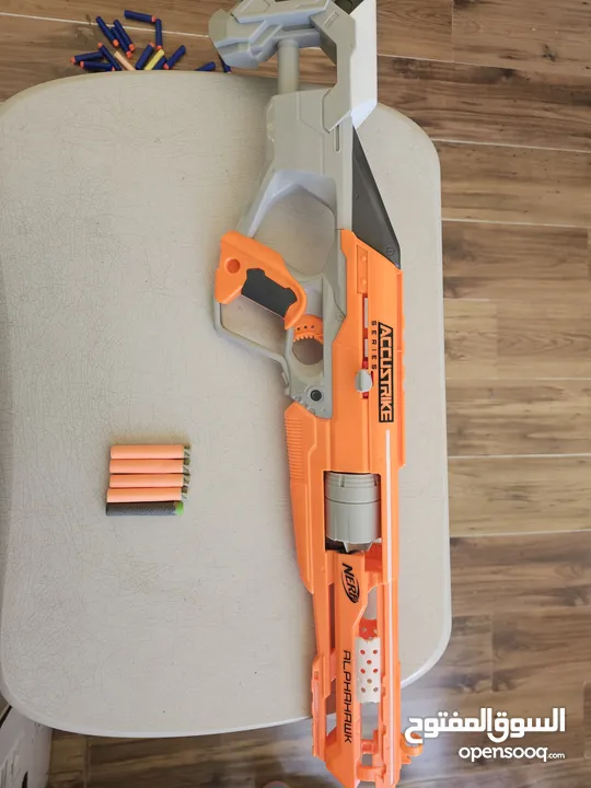 accustrike toy blaster with 5 bullets, 4 similar and 1 diffent