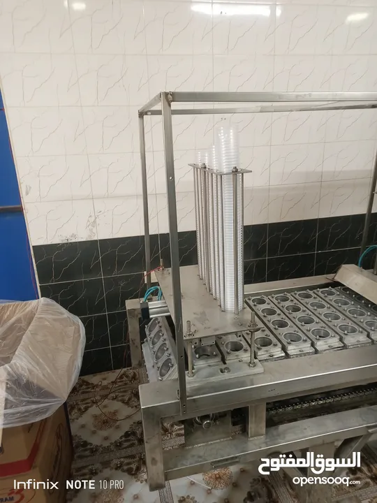 محطة مياه مع ماكنة ماينة تعبئة كاسات ماء