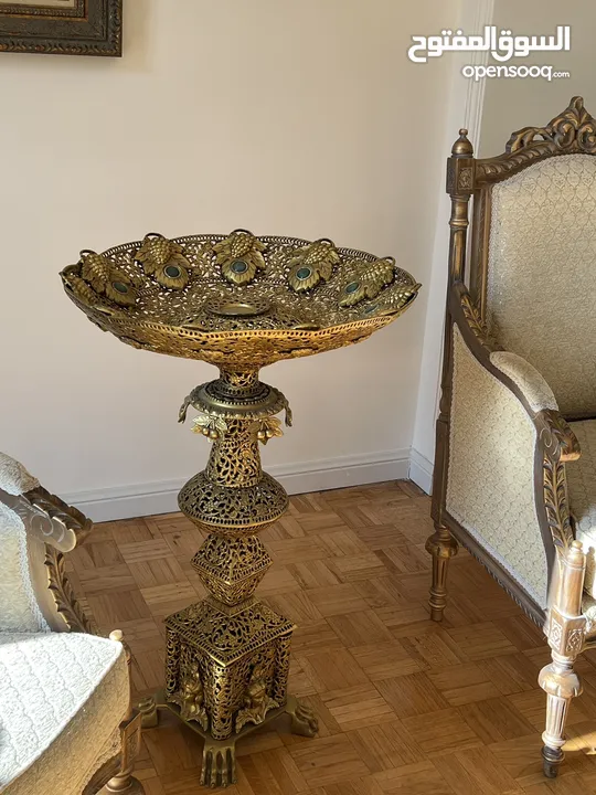 A tall brass fruit bowl