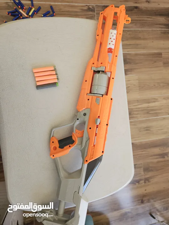 accustrike toy blaster with 5 bullets, 4 similar and 1 diffent