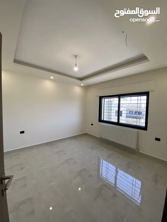 شقة طابق اخير مع روف 230 متر وتراس 100 متر على شارعين  طريق المطار خلف المدارس العالمية بسعر مميز