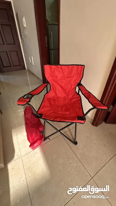 كرسي تخييم احمر جديد -"Red camping chair, new."