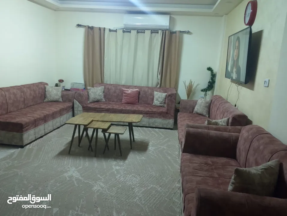 كنب مع طاولات وبرداي وسجادة