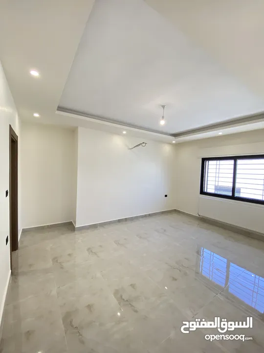 شقة طابق اخير مع روف 230 متر وتراس 100 متر على شارعين  طريق المطار خلف المدارس العالمية بسعر مميز