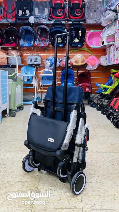 عرباية السفر من island toys ماركة NE الروسية  مع امكانية التحويل ل حقيبة يد للحمل