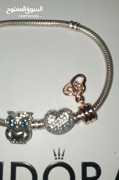 PANDORA sliver bracelet with heart shaped clasp with some charmsاسواة باندورا فضة بشكل قلب مع إضافات
