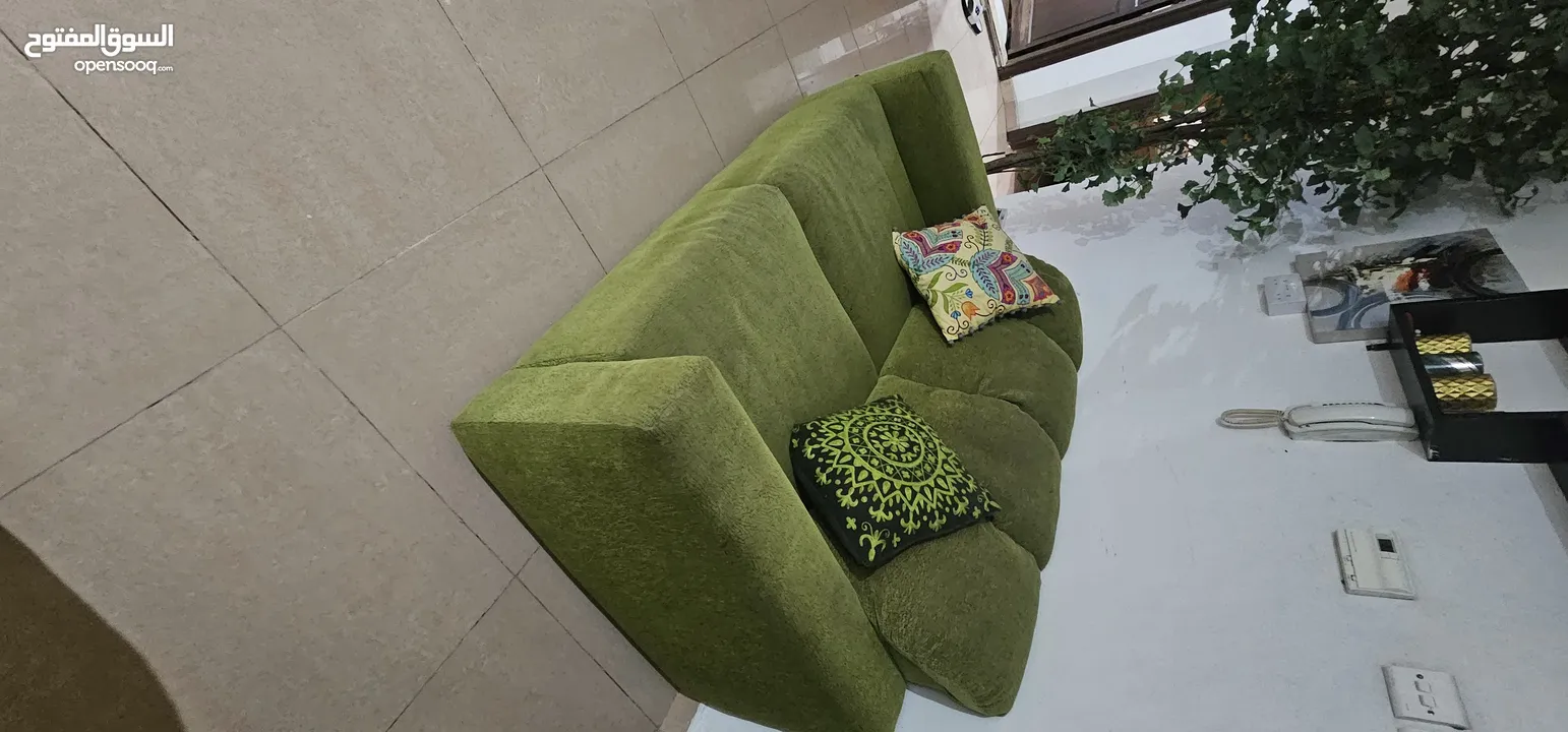 brown  corduroy sofa and green fabric sofa