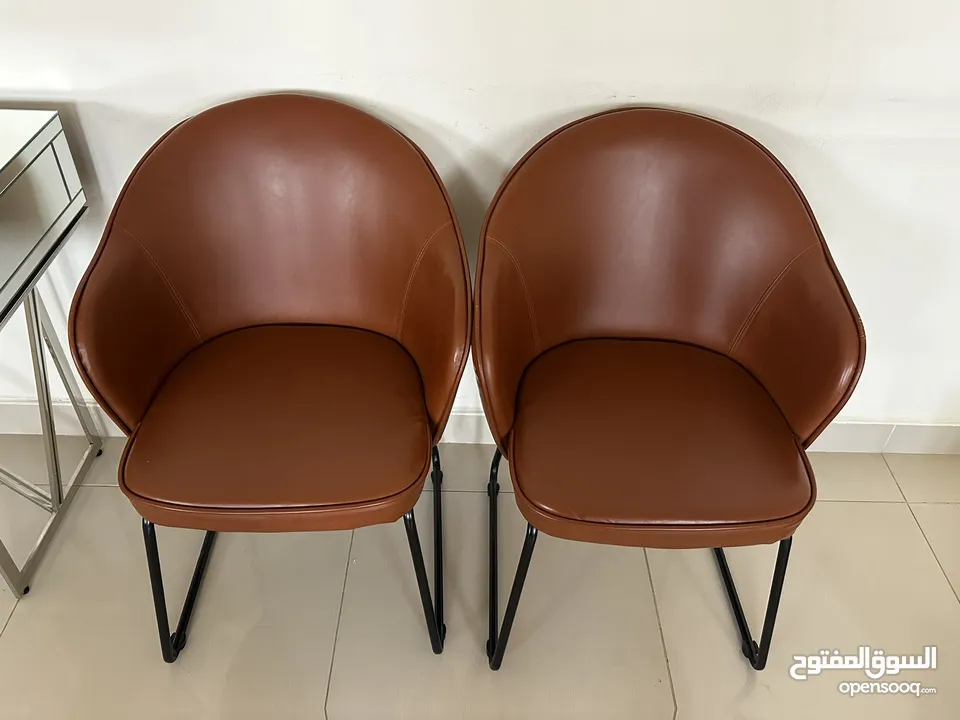 2 brown leather chairs