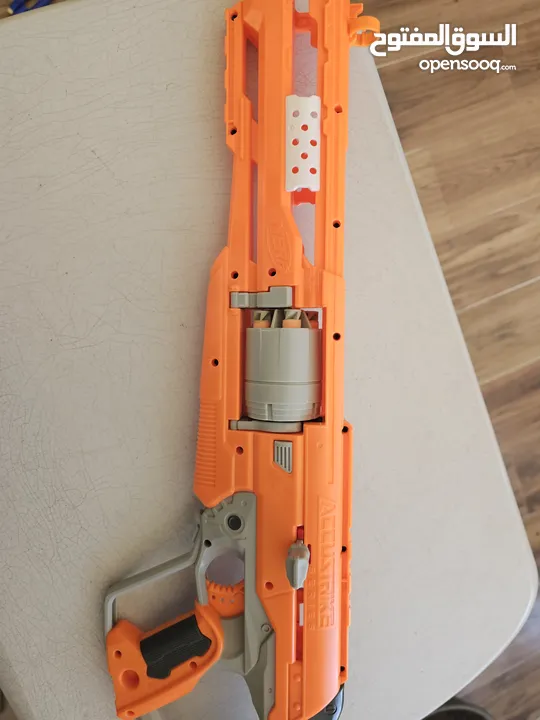accustrike toy blaster with 5 bullets, 4 similar and 1 diffent