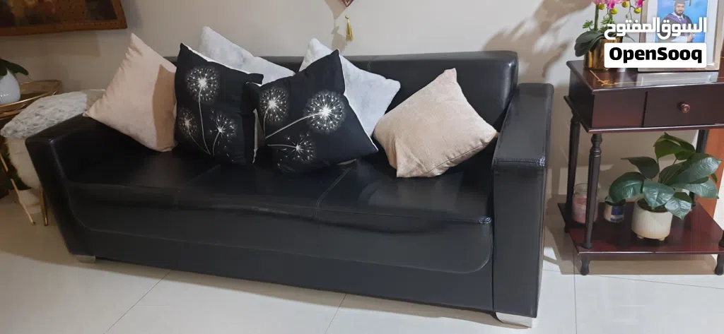 Three seater black leather sofa
